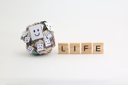 Crumpled paper, adorned with diverse expressions, symbolizes the complexities and contradictions within the human experience.の写真素材