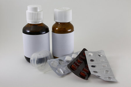 medicine bottle and pills on a white background with copy spaceの写真素材