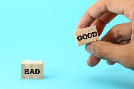 Wooden blocks with the word Good and Bad on blue background.の写真素材