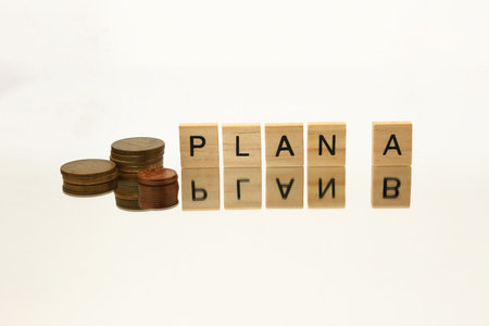 Plan A and B written with wooden blocks on a white background.の写真素材