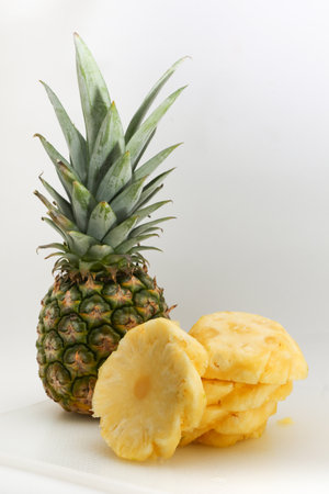 Pineapple and slices on a white background. Healthy food concept.の写真素材