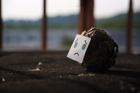 Crumpled paper with sad face on blurred backgroundの写真素材