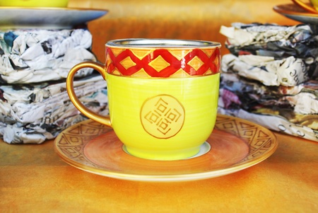 Decorated and colored teacup in the windowの写真素材