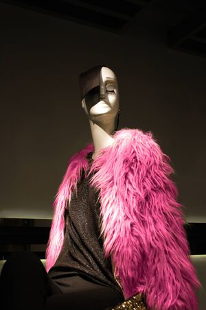 Elegant mannequin woman in the window with fuchsia furの写真素材