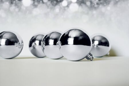 Photo of silver Christmas balls on bright backgroundの写真素材