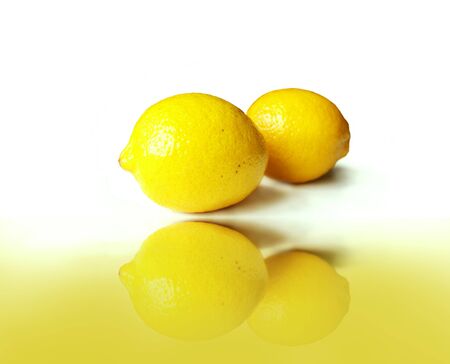 Two lemons in the white background with reflection aboveの写真素材