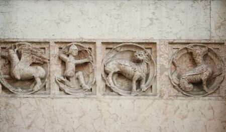 Medieval marble bas-relief representing mythological animals and an archerの写真素材