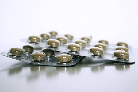 Photo of two packs of brown pills
