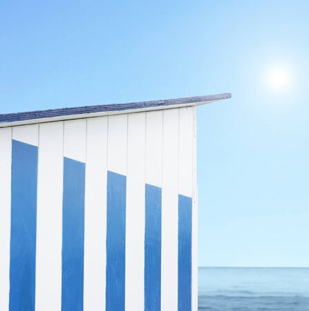 Detail of a cabin beach with sea, blue light and sun on the backgroundの写真素材
