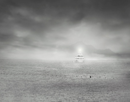 An isolated boat at sea with a dramatic sky in black and whiteの写真素材
