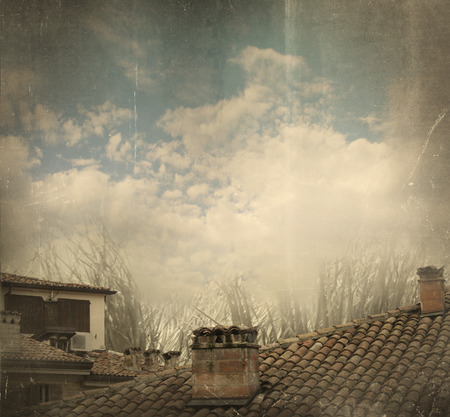 Roof and chimneys with a cloudy sky in a vintage styleの写真素材