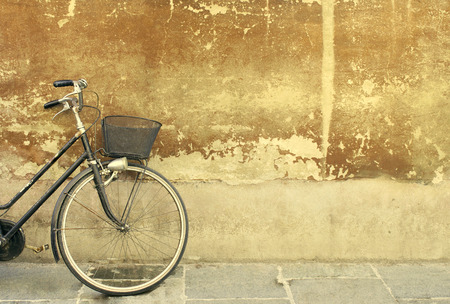 detail of a part of a bicycle leaning against an old wallの写真素材