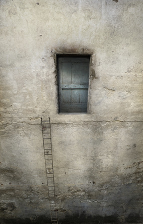 Surreal overhanging wall with door and a long staircaseの写真素材