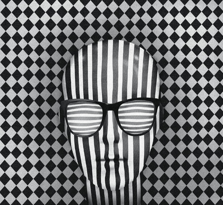 Graphic illustration with optical effect representing a person's head covered with vertical stripes with glasses horizontal stripes and white diamond pattern in black and whiteの写真素材