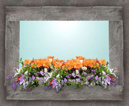 Colorful floral composition on a window sill with a window open on the skyの写真素材