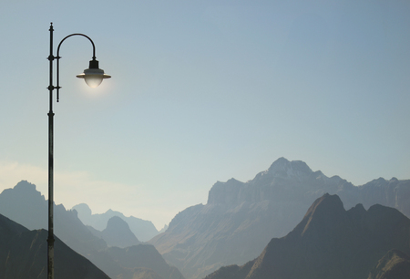 Beautiful and poetic view of Dolomites Alps in Italy with a street lamp detailの写真素材