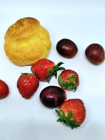 fresh strawberries and buns on a white background, closeup of photoの写真素材