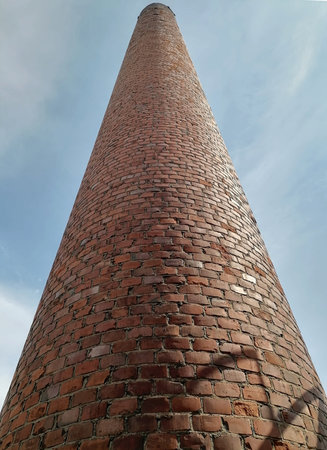 Old brick chimney against the blue skyの写真素材