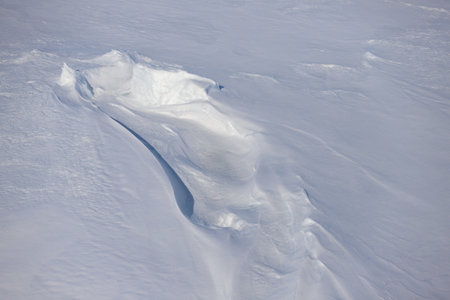 Aerial view of the surface of the snow in the mountains.