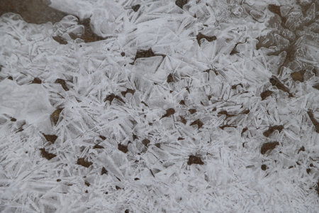 ice crystals on the ground in winter, close-up of photoの写真素材