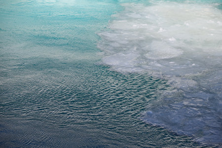 water surface with ripples and ice in the seaの写真素材