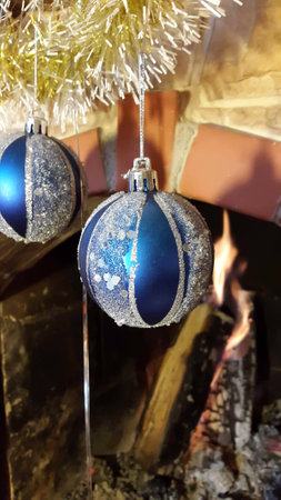 Christmas decoration fireplace with blue glass balls and gold garlandの写真素材