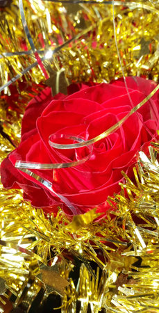 Christmas decoration natural red rose and gold tisel with starsの写真素材
