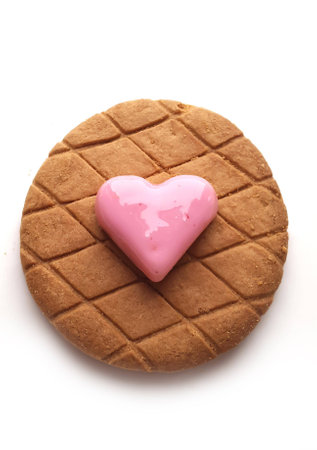 Sweet red marzipan heart and Crunchy fresh biscuits on a white backgroundの写真素材