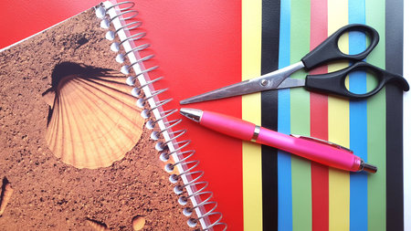 Color papers geometry flat composition background with pink pen and scissorsの写真素材