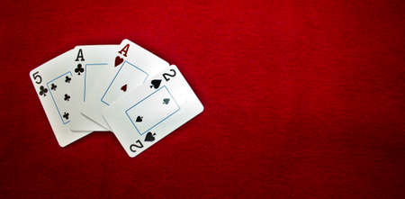 Pot limit omaha poker: Weak aces as starting hand on red background with copyspace.の写真素材