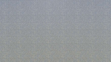 Texture of a wall made of gray tiles. Abstract background for design.の写真素材