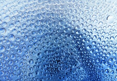 Beautiful Blue Dew Drops.Rain Drops In The Glassの写真素材