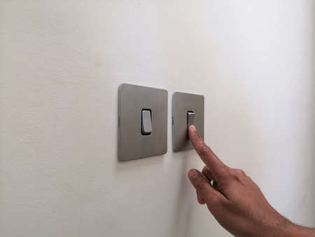 Turning On Electrical Switch With Male Fingerの写真素材