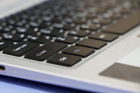 Side View Of White Laptop Key Pad. Selective Focus