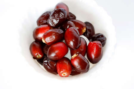 Beautiful Tasty Fresh Dark Red Dates Fruit Or Date Palm In White Background. Selective Focus