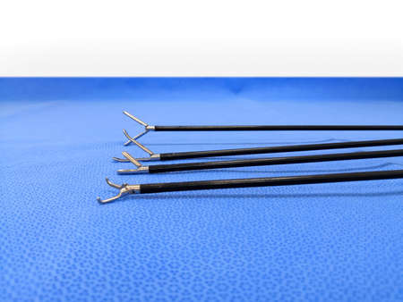 Laparoscopic Surgical Instrument Tip In Blue Background. Selective Focus To Grasper Forceps Tip