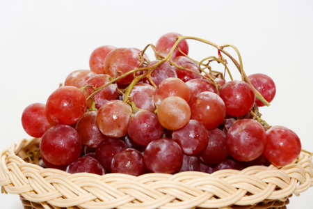 Closeup Image Of Fresh Red Grapes In White Isolated Backgroundの写真素材