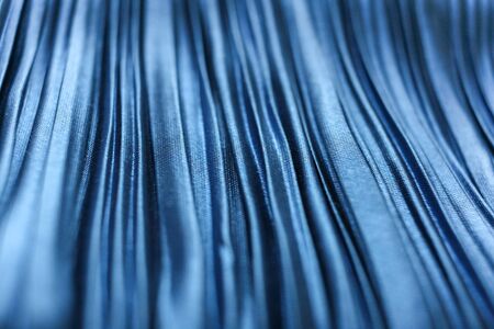 Blue textured crinkled fabric closeup. Selective focus.の写真素材