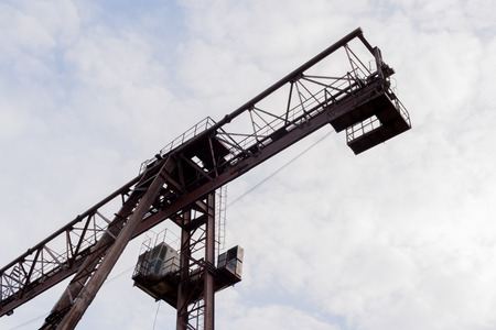 Part of the crane against cloudy sky. Bottom view.の写真素材