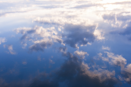 Reflection of blue sky and white clouds in water.の写真素材