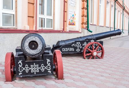 Syzran, Russia - August, 16,2016: Two black cannons with red wheels as installation near the City Lore Museum.のeditorial素材