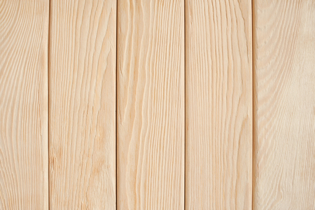 Wooden background of light vertical brushed boards.