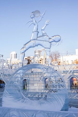 Yekaterinburg, Russia - January,13,2018: Icy sculpture of football player with ball, dedicated to 2018 Mundial, in icy town in city center.のeditorial素材