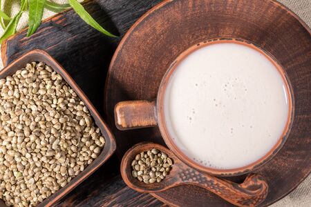Top view hemp milk and grains in brown ceramic crockery.の写真素材