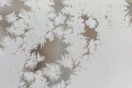 Frosty fancy pattern on window glass. Selective focus.
