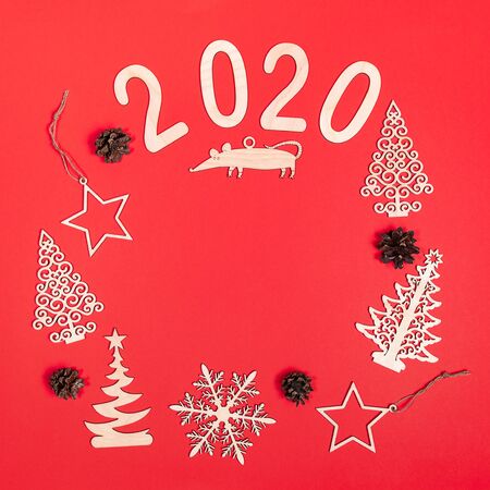 Creative christmas mockup on red background with handmade wooden xmas decorations: Christmas trees,...