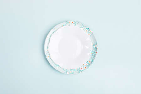 Spring festive minimal composition with two empty beautiful plates on center of light blue backdrop...