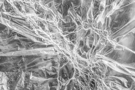 Interesting texture of white melted polyethylene. Smoothed and melted parts of celluloid film alternates creating a fantasy pattern. background or wallpapers. soft focus. horizontal orientation.の写真素材