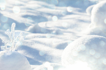 Magic of winter nature. Christmas or winter card with snowy twigs, snowballs, sun glare and...