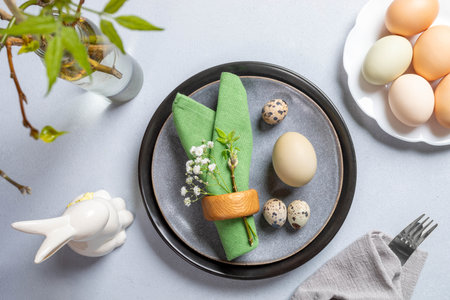 Easter table setting arrangement top view. Trendy holiday table in natural colors. Round and figured...